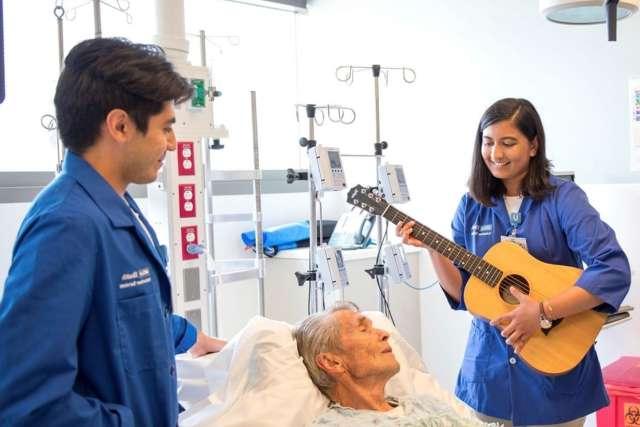 Volunteer musicians playing to patient.