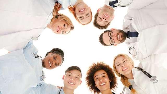 Diverse doctors forming a circle to demonstrate unity.